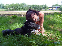 Zoo slut with saggy tits fucks outdoor with a black dog - picture 1