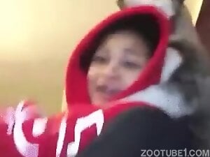 Dog starts humping a horny brunette in a red hoodie