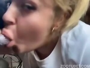 Sweet blonde sucking dog dick